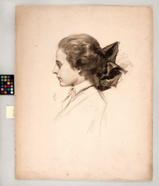 Profile view of young woman with hair bow at back of neck