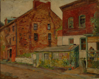 Street scene with brick buildings and small frame house