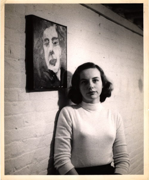 Grace Hartigan standing next to her self portrait, 1953. Image courtesy Grace Hartigan Papers m…