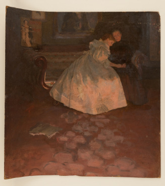 Two women seated on couch in front of fireplace