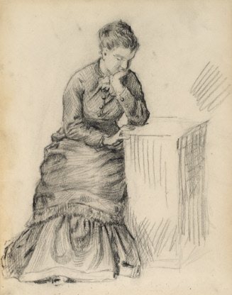 Woman seated with hand on chin